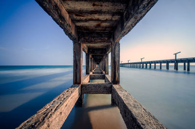 Pier over sea against sky