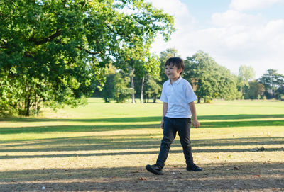 Full length of boy walking at park