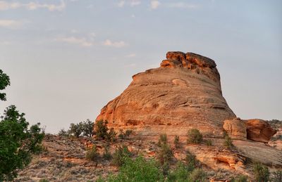 Rock formations on landscape against sky