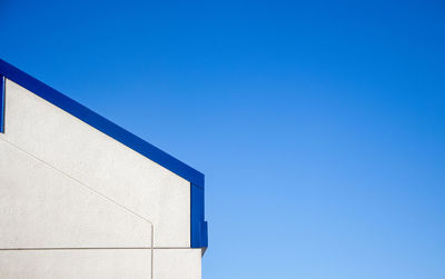 Low angle view of building against clear blue sky