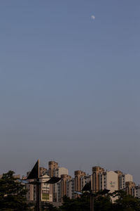 Distant view of city against sky at dusk