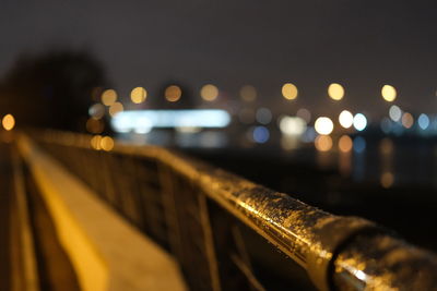 Close-up of illuminated railing at night