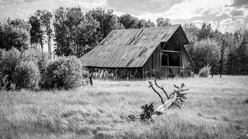 Abandoned barn on grassy field