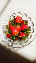 High angle view of strawberries in bowl on table