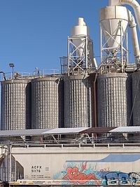 Low angle view of industrial building against clear blue sky