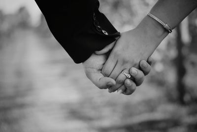 Close-up of couple holding hands