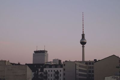 Fernsehturm amidst buildings against clear sky in city