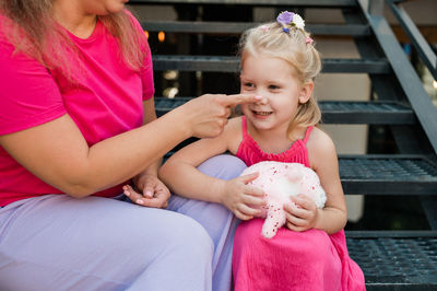 Portrait of cute girl playing with toy at home