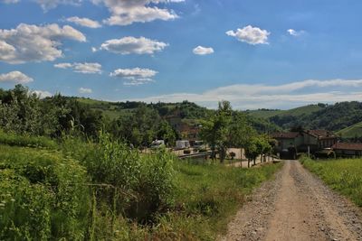 Scenic view of village by houses against sky