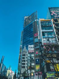 Low angle view of buildings against blue sky