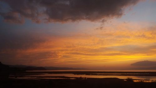 Scenic view of dramatic sky over sea during sunset