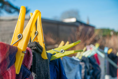 Close-up of multi colored clothespins hanging on clothesline