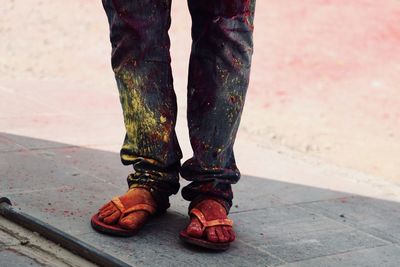 Low section of man covered with powder paint standing outdoors