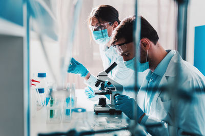 Scientist examining patient in laboratory