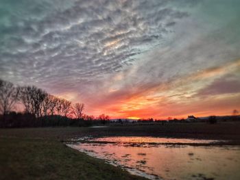 Scenic view of landscape against sky at sunset