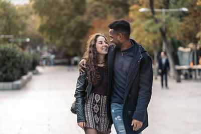 Smiling couple walking on road