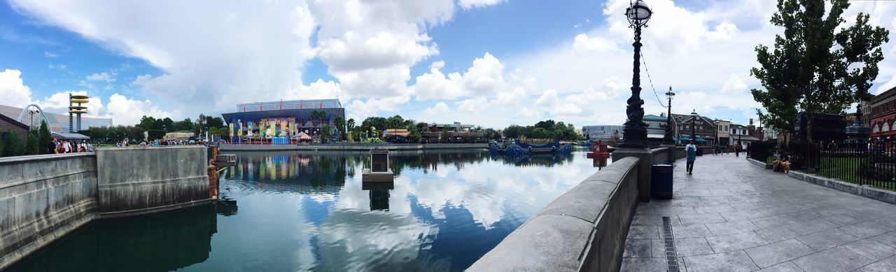 water, architecture, built structure, sky, panoramic, building exterior, reflection, cloud - sky, city, tree, sidewalk, walkway, cloud, travel destinations, pedestrian walkway, waterfront, day, canal, tourism, promenade, diminishing perspective, city life, famous place, footpath, narrow, old town