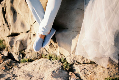 Low section of woman standing on rock