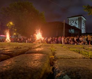 Surface level of people by bonfire at night