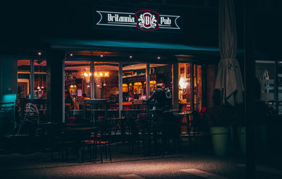 Illuminated sign on table in restaurant at night