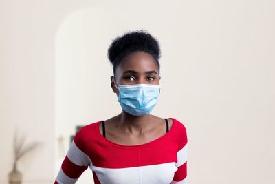 Portrait of young woman over white background