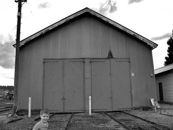 Closed door of building against sky