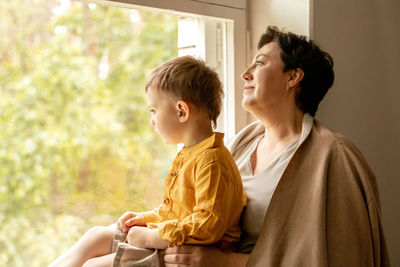 Happy grandmother and grandson enjoy time together. positive middle age woman