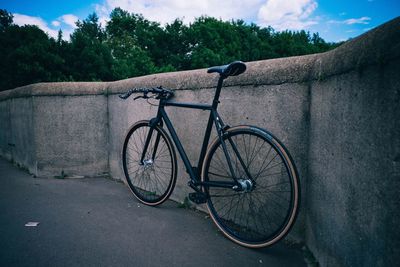 Bicycle parked by wall