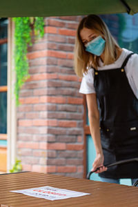 Full length of woman standing on table