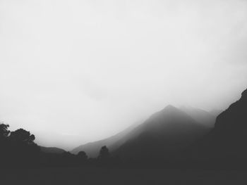 Scenic view of silhouette mountains against clear sky