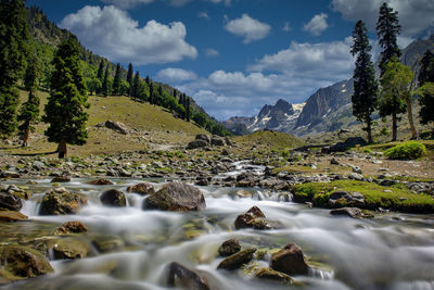 Scenic view of waterfall against sky