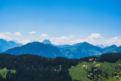 Scenic view of mountains against blue sky