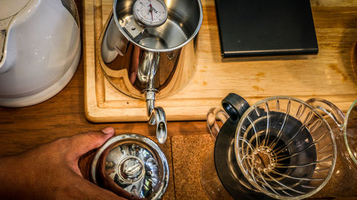 High angle view of hand holding clock