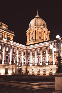 Low angle view of illuminated building against sky at night