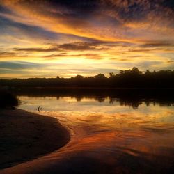 Scenic view of lake at sunset