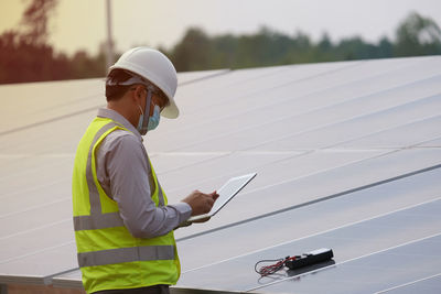Rear view of man working on road