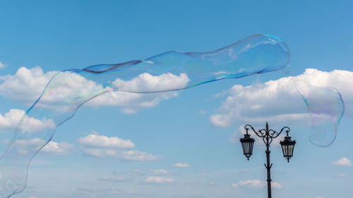 Low angle view of street light against sky