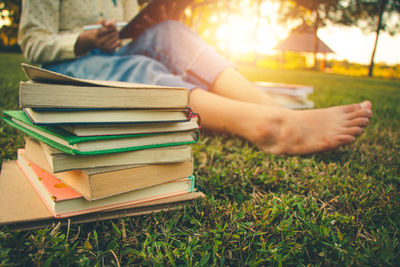 Man reading book on field