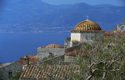 Panoramic view of building and mountains against sky