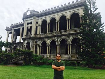 Portrait of smiling man standing against building