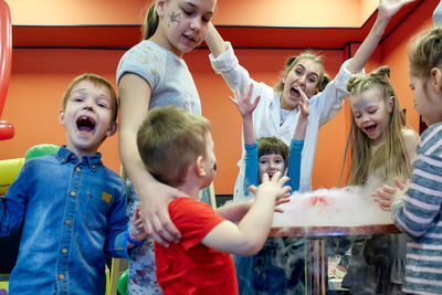 Portrait of siblings with toys at event