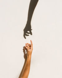 Silhouette of two hands are drawn to each other on a white background