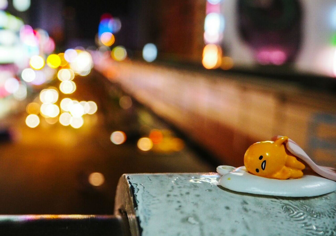 illuminated, focus on foreground, indoors, selective focus, table, night, close-up, decoration, yellow, toy, multi colored, lighting equipment, still life, celebration, christmas, candle, no people, defocused, art and craft, incidental people