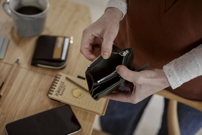 Man's hands holding wallet