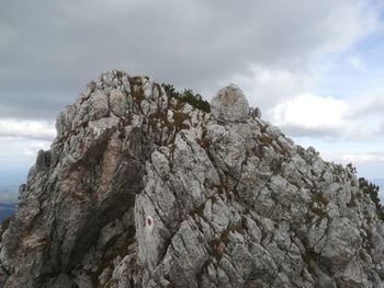 Low angle view of rock formation against sky