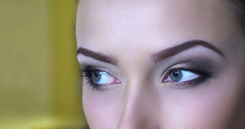 Cropped image of thoughtful woman with make-up