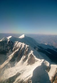 Scenic view of snowcapped mountains against clear sky