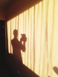 Silhouette of woman photographing through camera