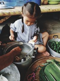 High angle view of cute girl preparing food