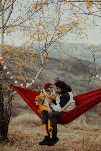 Young woman sitting on hammock